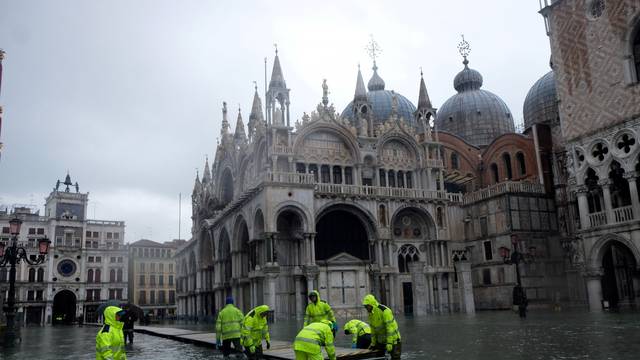 FILE PHOTO: Workers put up a platform at a flooded St. Mark's Square in Venice
