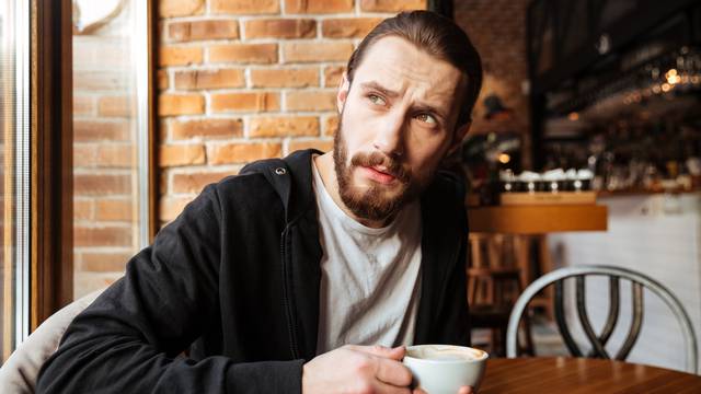 Serious Bearded man in cafe