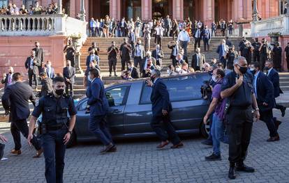 The hearse carrying the casket of soccer legend Diego Maradona drives past the presidential palace Casa Rosada, in Buenos Aires