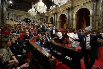 Deputies from PSC, PP, and Ciudiadanos abandon the chamber during a plenary session at the Catalan regional Parliament in Barcelona