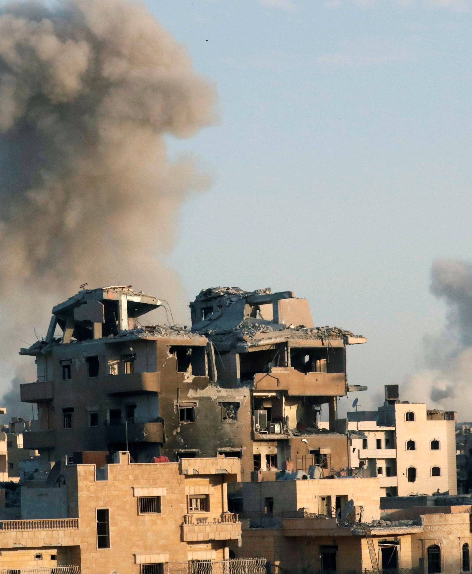 Smoke billows at different positions of the Islamic State militants at the stadium after an air strike by coalition forces, at the frontline in Raqqa