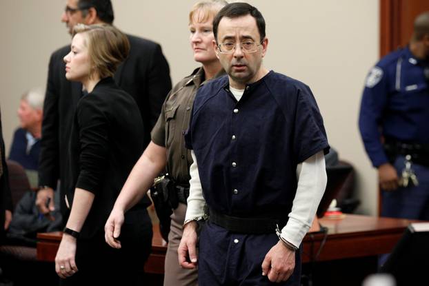 Larry Nassar, a former team USA Gymnastics doctor who pleaded guilty in November 2017 to sexual assault charges, arrives in the courtroom during his sentencing hearing in Lansing