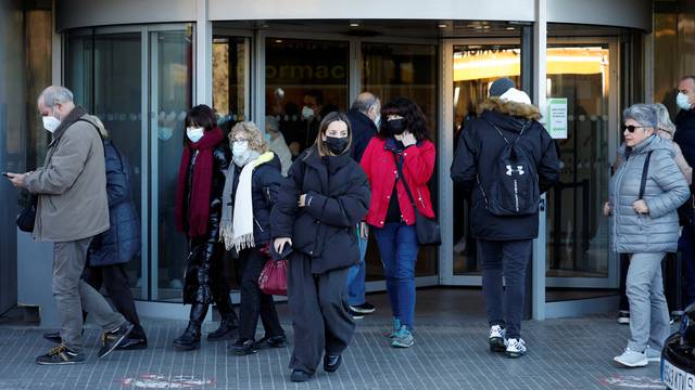 People wearing protective masks leave Germans Trias y Pujol Hospital in Badalona