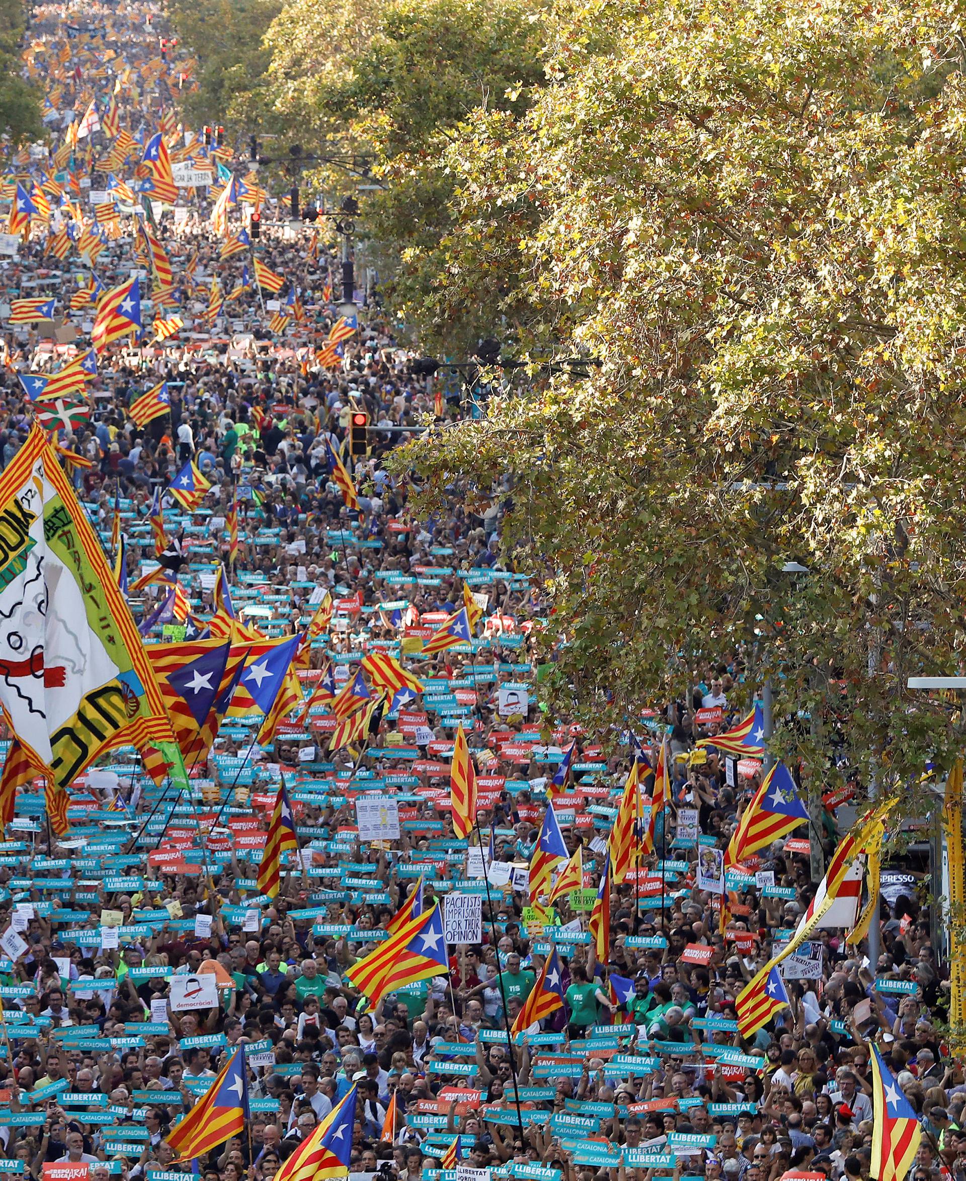 People wave Catalan separatist flags during a demonstration organised by Catalan pro-independence movements ANC (Catalan National Assembly) and Omnium Cutural, following the imprisonment of their two leaders Jordi Sanchez and Jordi Cuixart, in Barcelona