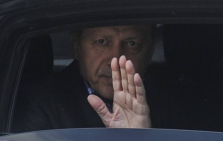 Turkish President Erdogan waves from his car after leaving his residence in Istanbul
