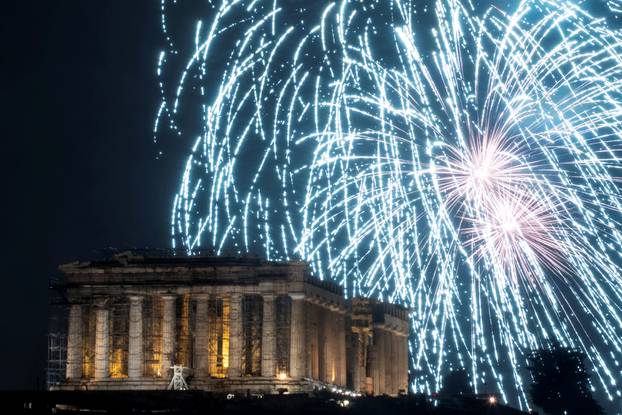 Fireworks explode over the ancient Parthenon temple atop the Acropolis hill during New Year