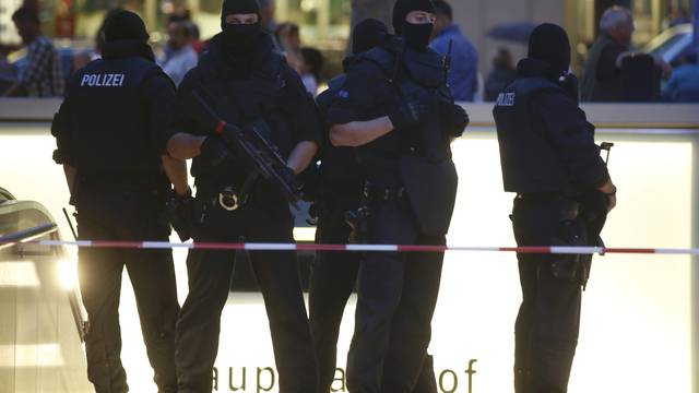 Special force police officers stand guard at entrance of main train station following shooting rampage at shopping mall in Munich