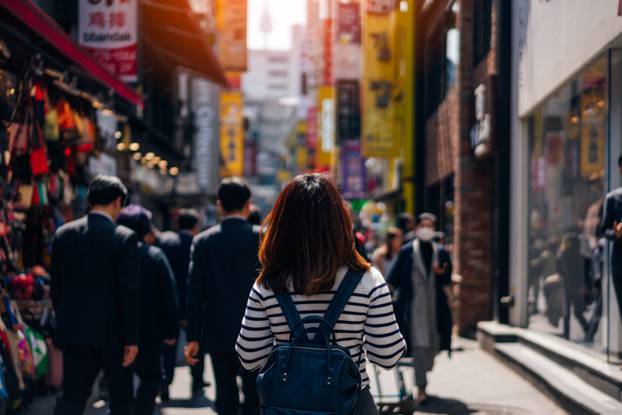 Young,Asian,Woman,Traveler,Traveling,And,Shopping,In,Myeongdong,Street