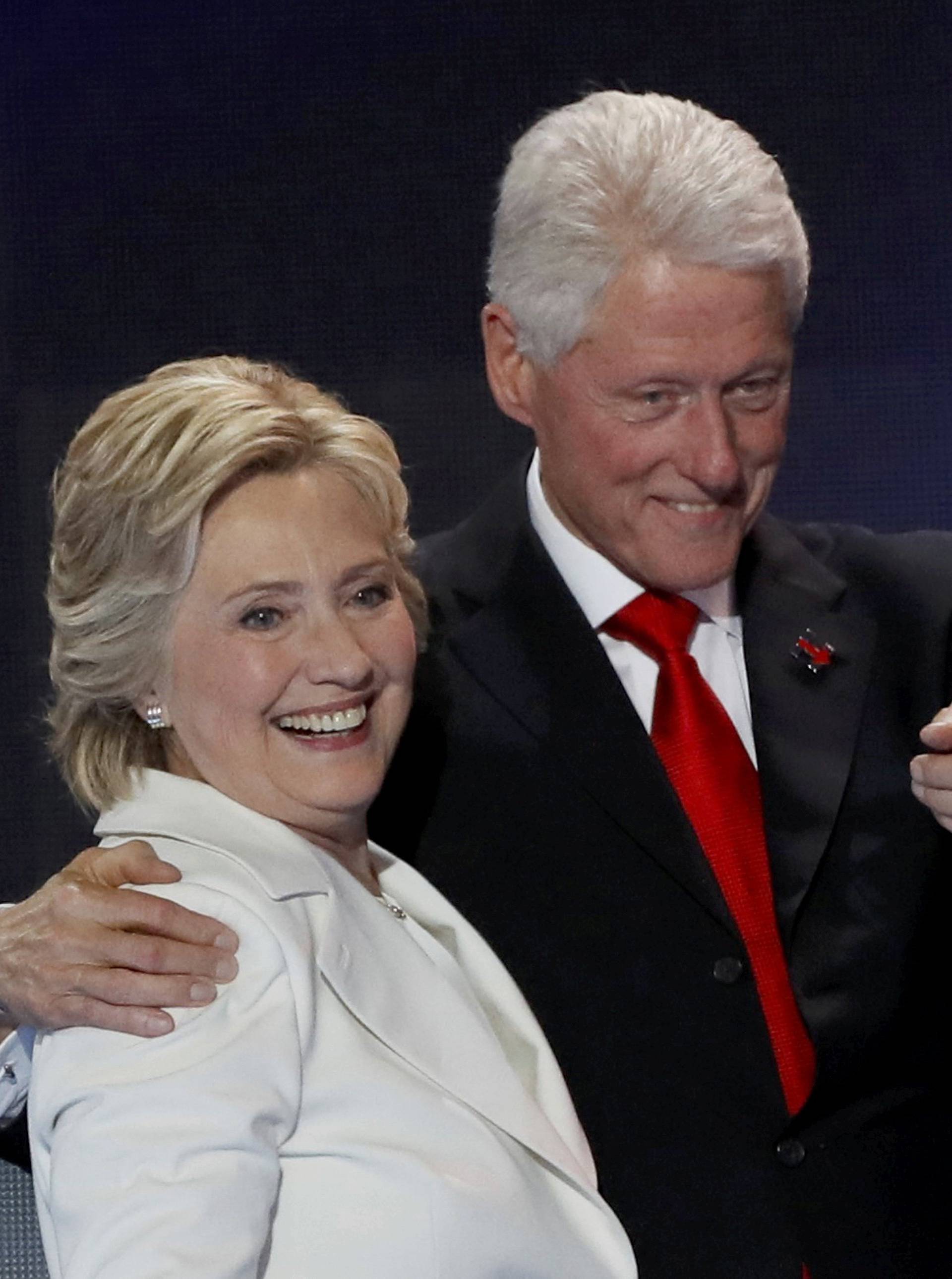 Democratic presidential nominee Hillary Clinton stands with her husband Bill Clinton after accepting the nomination on the final night of the Democratic National Convention in Philadelphia