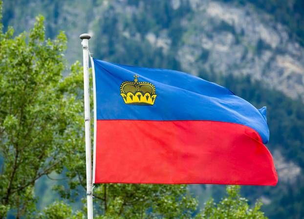 Liechtenstein flag waving on mountain background