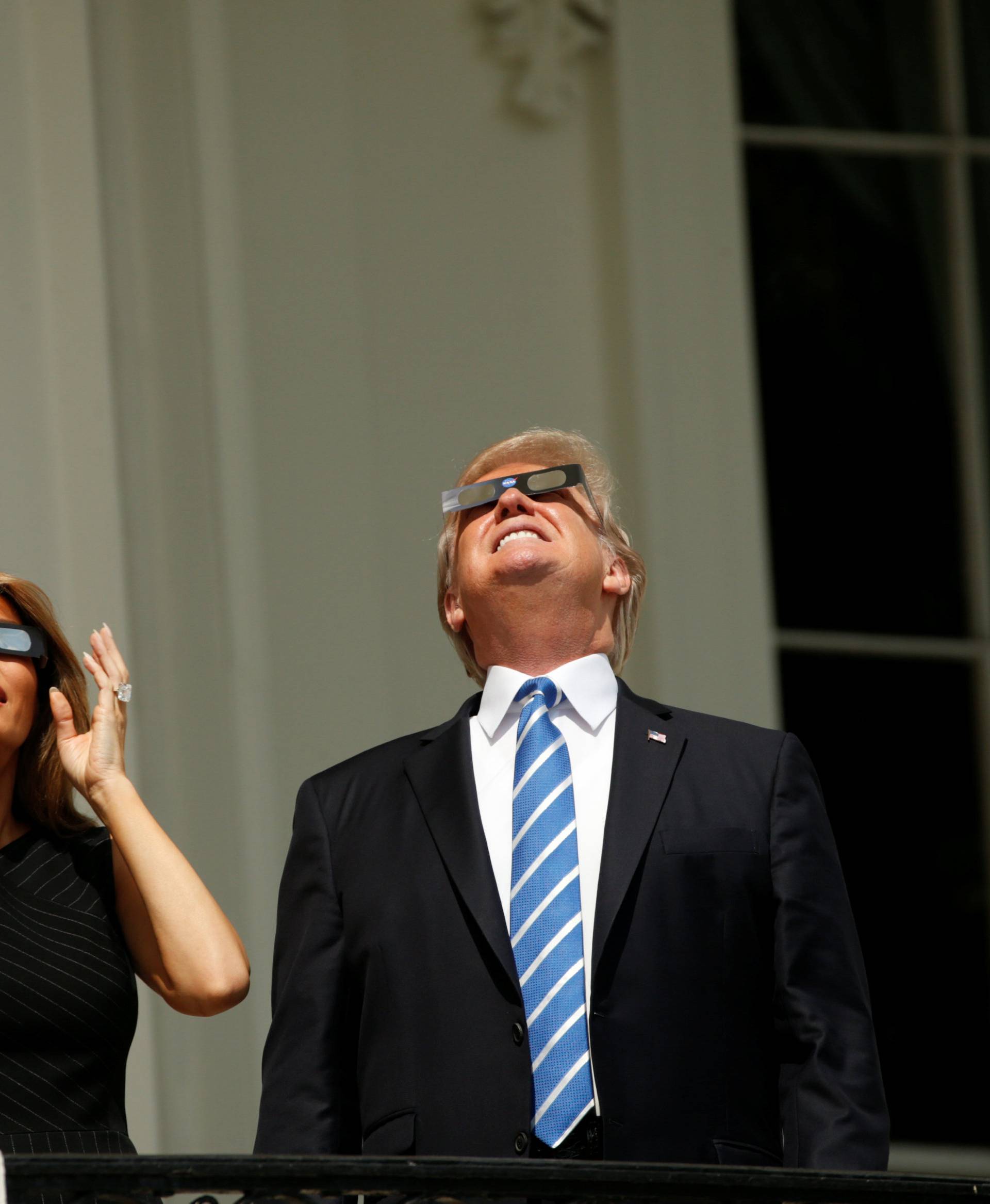 U.S. President Trump watches the solar eclipse with first Lady Melania Trump from the Truman Balcony at the White House in Washington