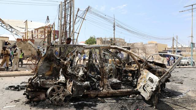 The wreckage of a car is seen at the scene of a bomb explosion