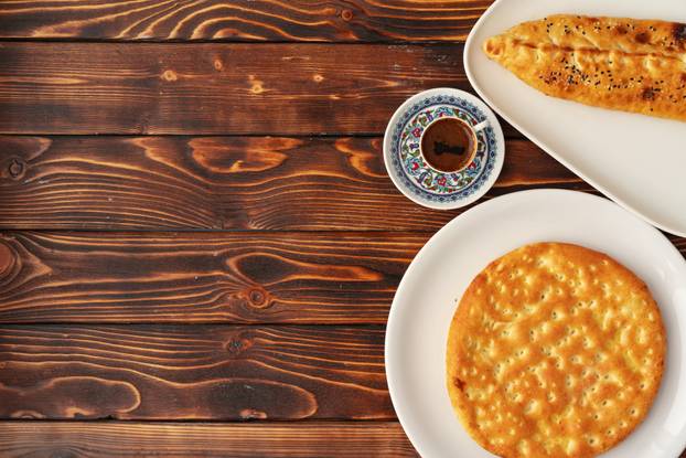 Baked homemade flatbread on wooden background close up