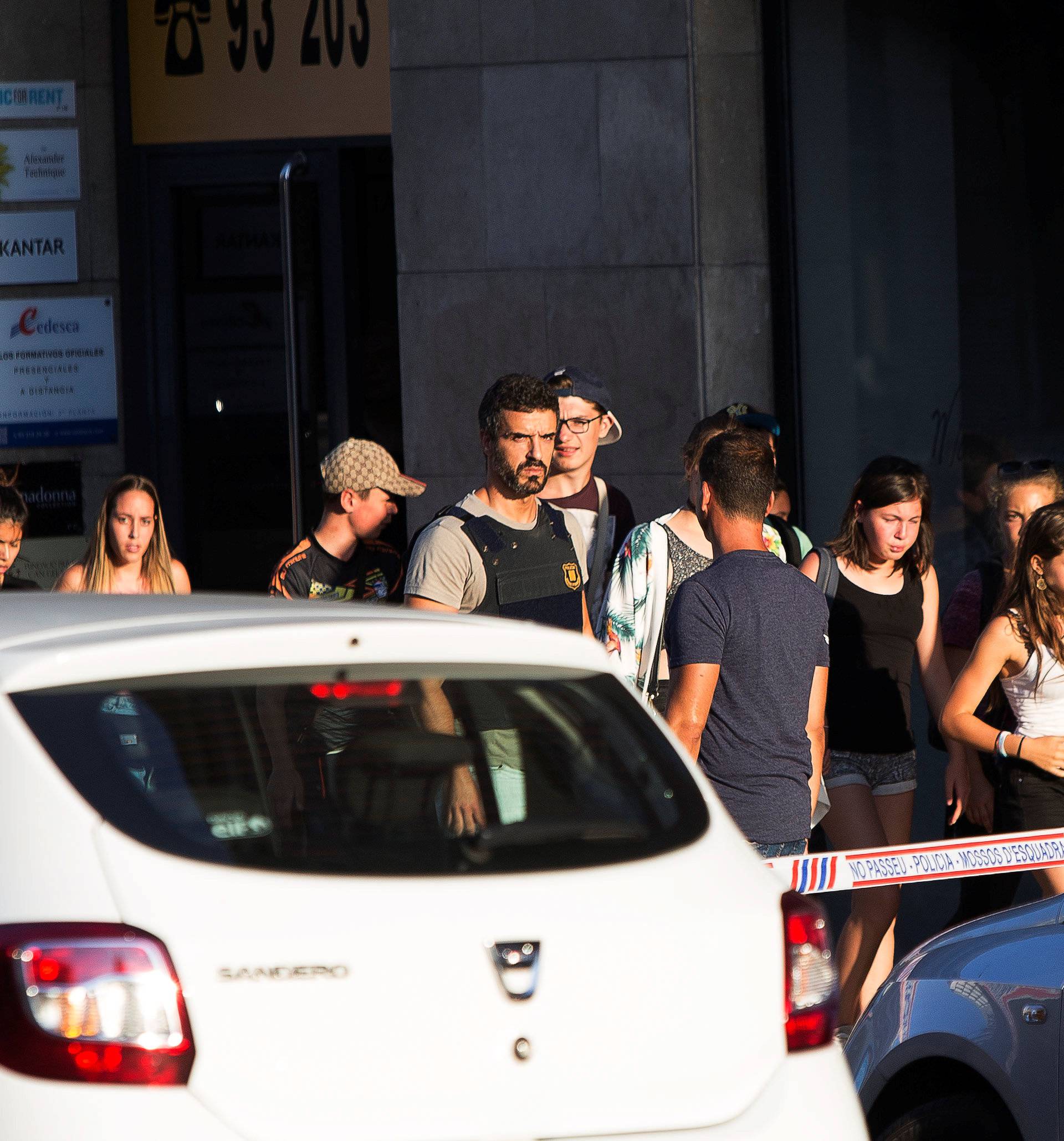 Police evacuate people after a van crashed into pedestrians near the Las Ramblas avenue in central Barcelona