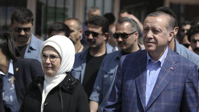 Turkish President Tayyip Erdogan and his wife Emine leave a polling station in Istanbul
