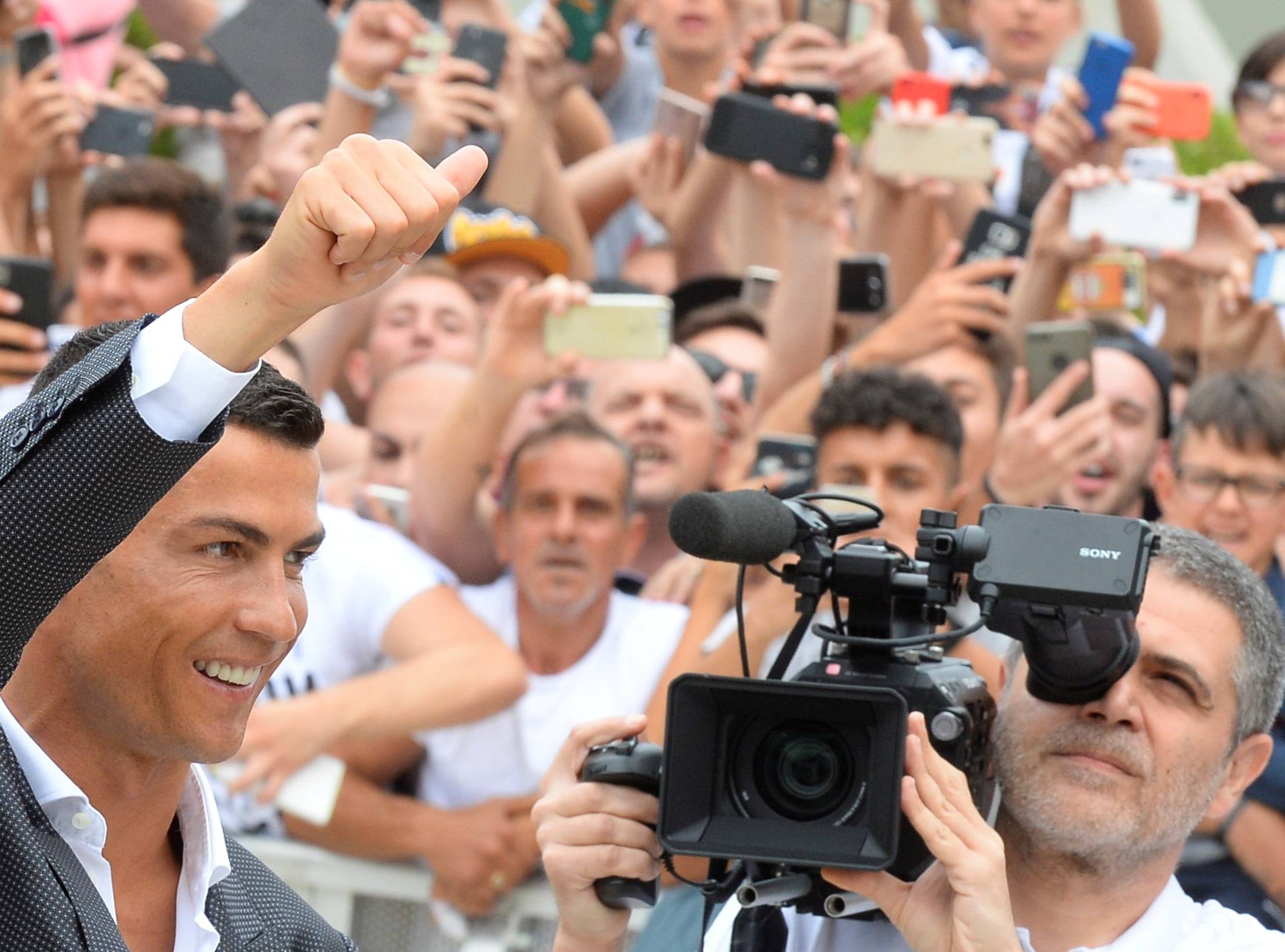 FILE PHOTO: Cristiano Ronaldo gestures as he arrives at the Juventus' medical center in Turin