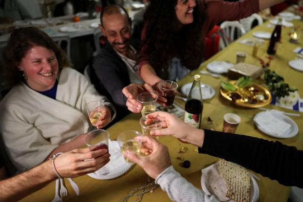 Israelis hold a Passover Seder in an underground parking garage used as a public bomb shelter, in Tel Aviv