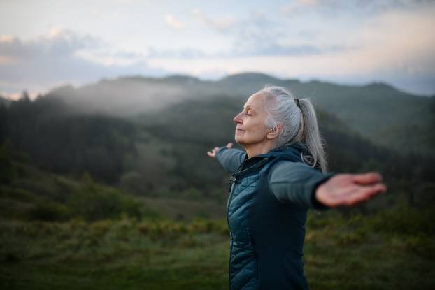 Senior,Woman,Doing,Breathing,Exercise,In,Nature,On,Early,Morning