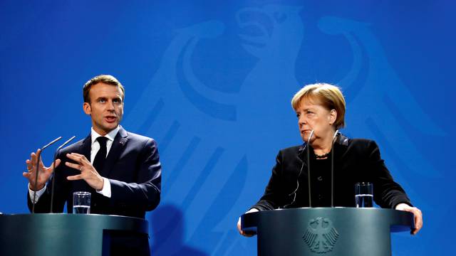 French President Macron and German Chancellor Merkel speak to reporters ahead of their meeting in Berlin