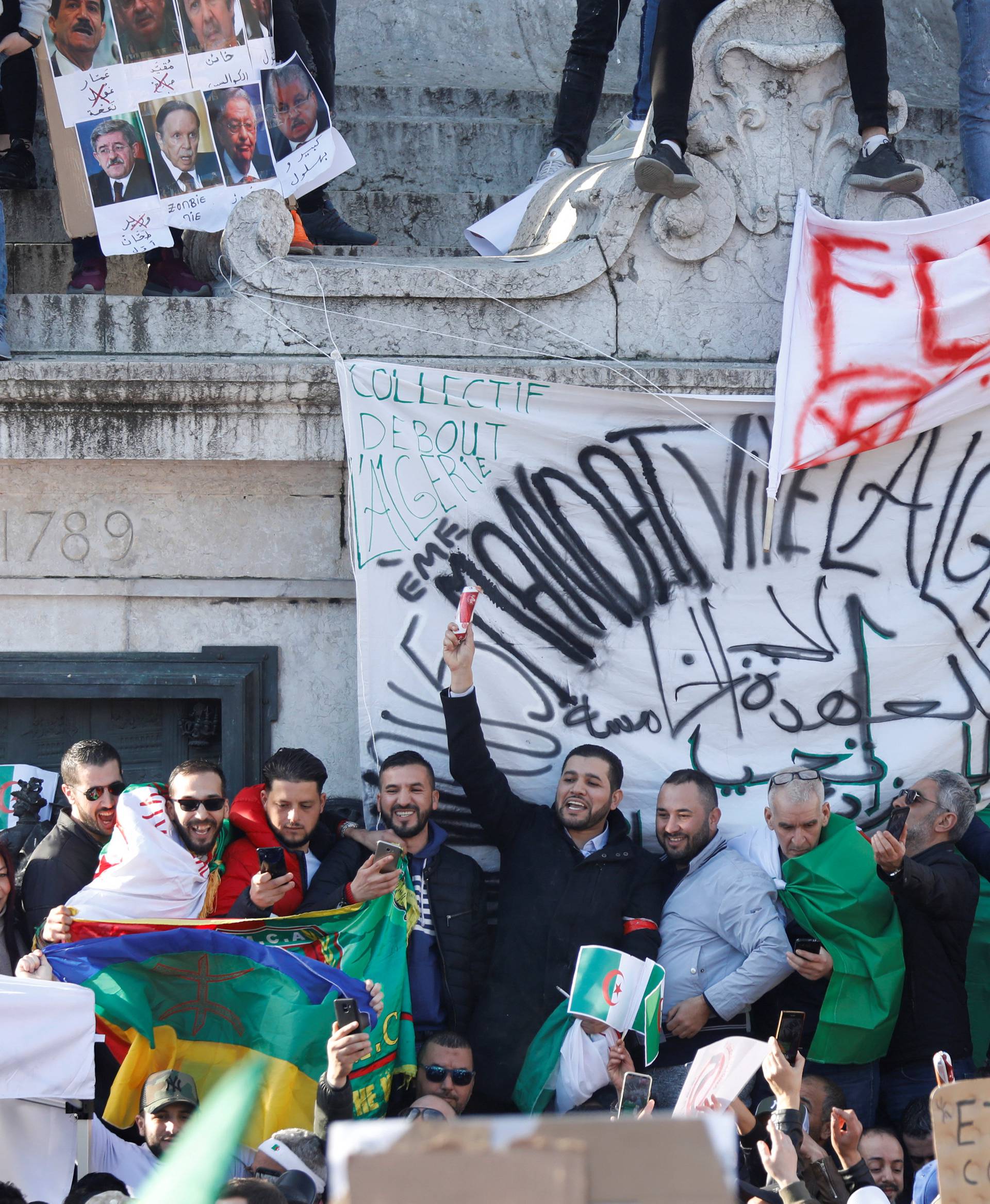 Demonstrators gather around the Monument to the Republic during a protest against President Abdelaziz Bouteflika in Paris