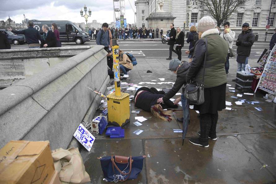 A woman lies injured after a shottingt incident on Westminster Bridge in London