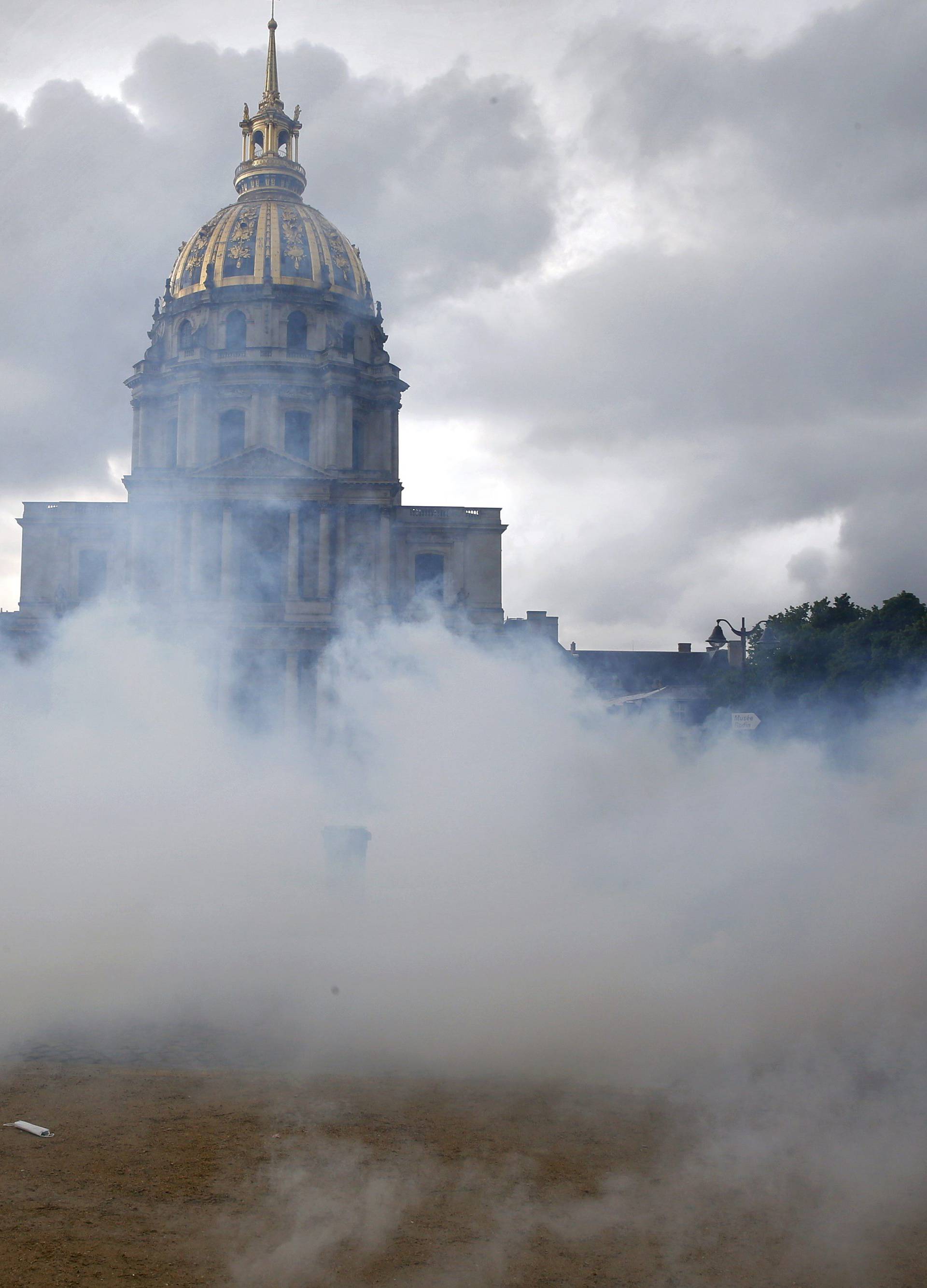 Clouds of teargas waft across the Invalides esplanade during a demonstration against French labour law reform in Paris