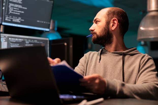 Web,Developer,Analyzing,Source,Code,With,Papers,And,Computer,,Taking