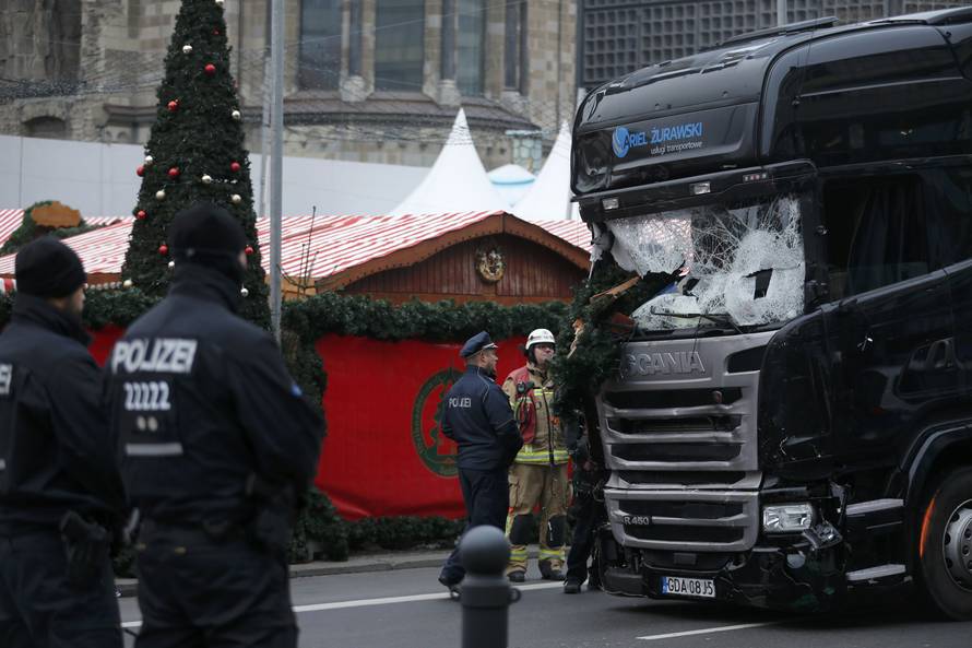 Police stand in front of the truck which ploughed last night into a crowded Christmas market in the German capital Berlin