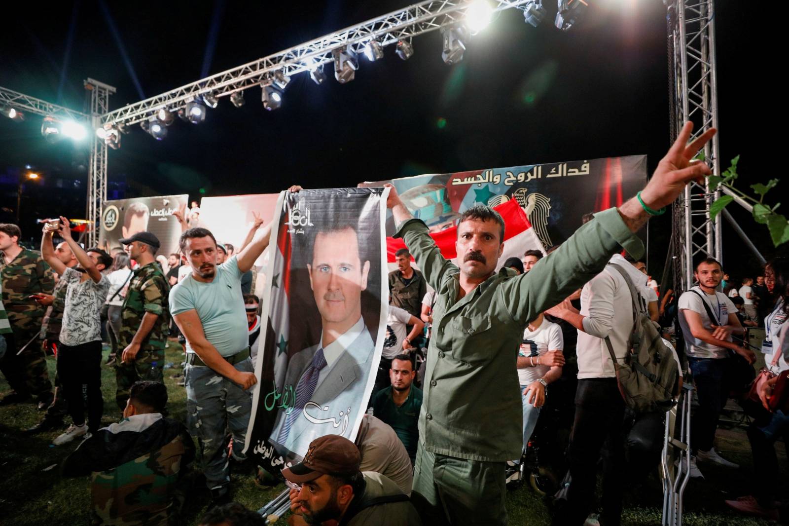 Supporters of Syria's President Bashar al-Assad celebrate before the results of the presidential election in Damascus