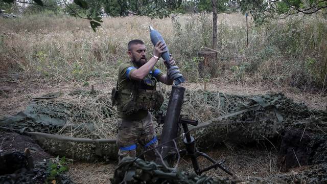 Ukrainian servicemen fires a 120-mm mortar towards Russian troops at a frontline near the town of Chasiv Yar