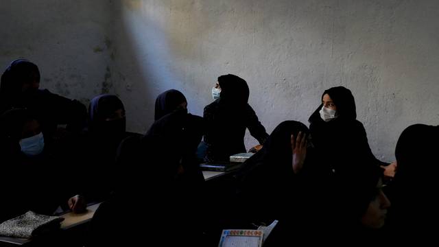FILE PHOTO: Afghan women learn how to read the Koran in a madrasa or religious school in Kabul