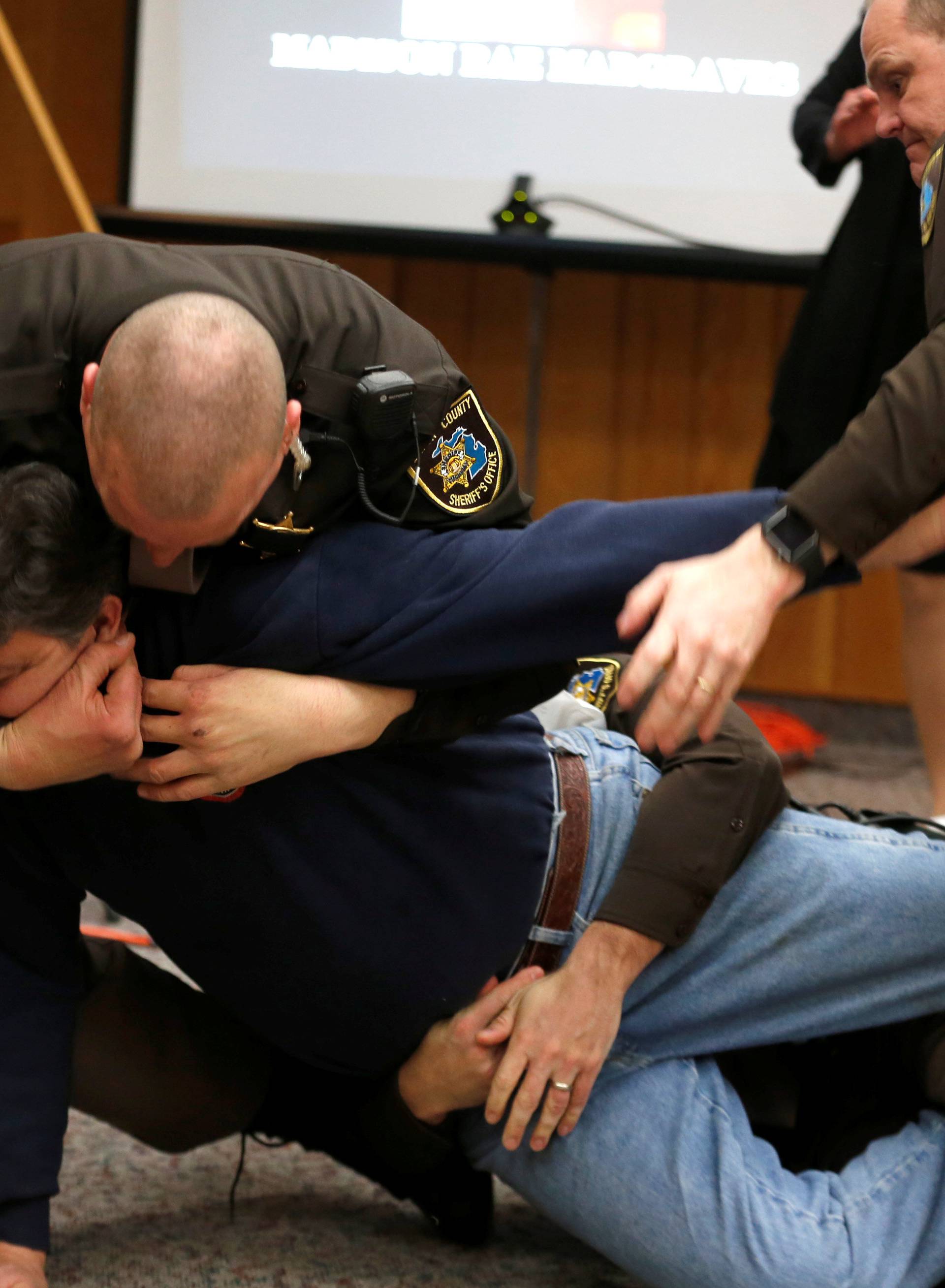 Eaton County Sheriffs restrain Randall Margraves after he lunged at Larry Nassar,during victim statements of his sentencing in the Eaton County Circuit Court in Charlotte