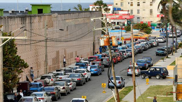 Drivers line up in their cars to buy fuel at a gas station in Havana