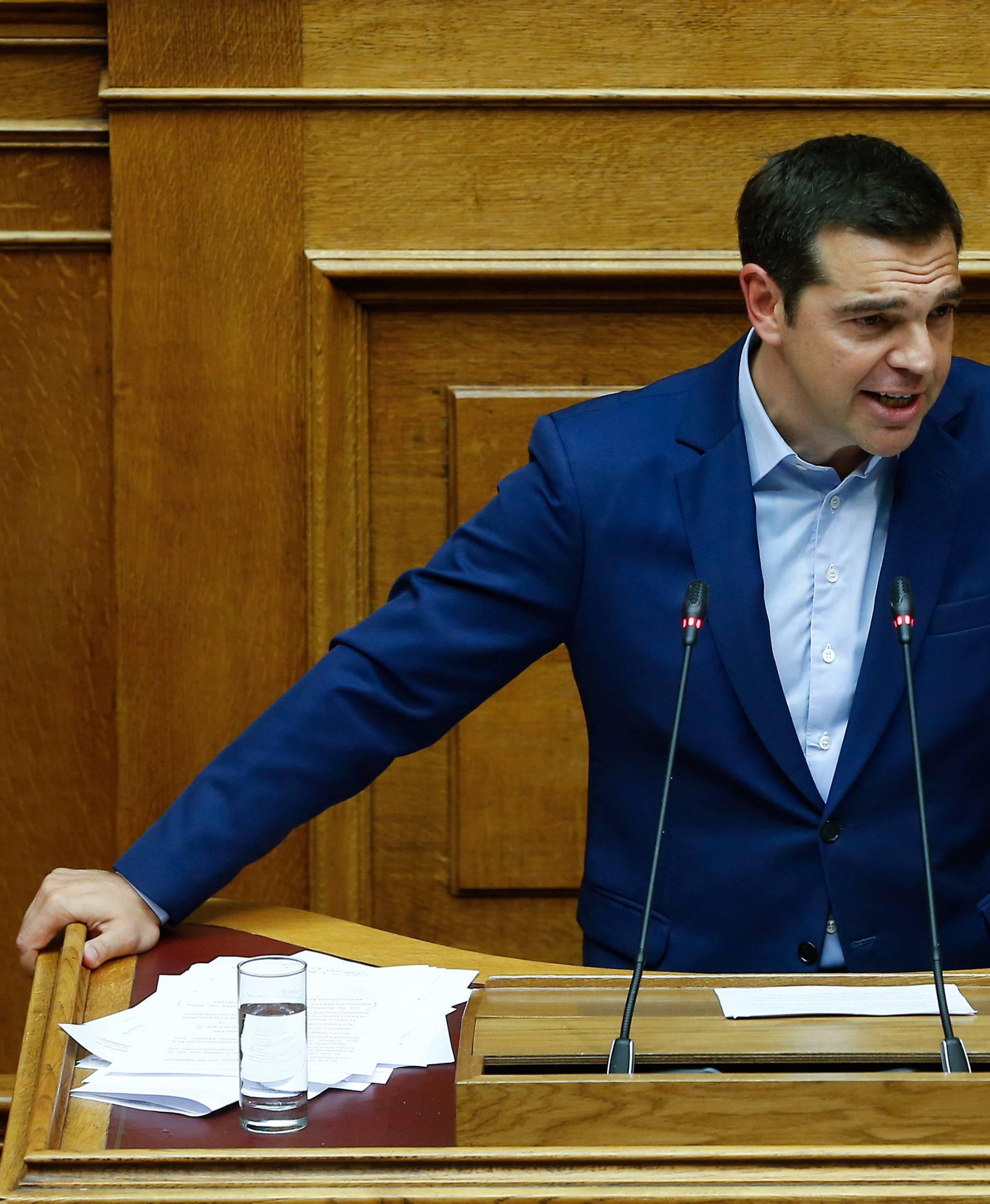 Greek Prime Minister Alexis Tsipras addresses lawmakers during a parliamentary session before a vote following a motion of no confidence by the main opposition in dispute over a deal on neighbouring Macedonia's name, in Athens