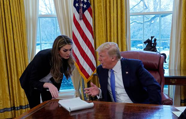 U.S. President Donald Trump speaks with Hope Hicks during an interview with Reuters in Washington