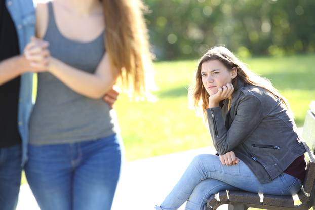 Single,Envious,Girl,Sitting,On,A,Bench,And,Seeing,An