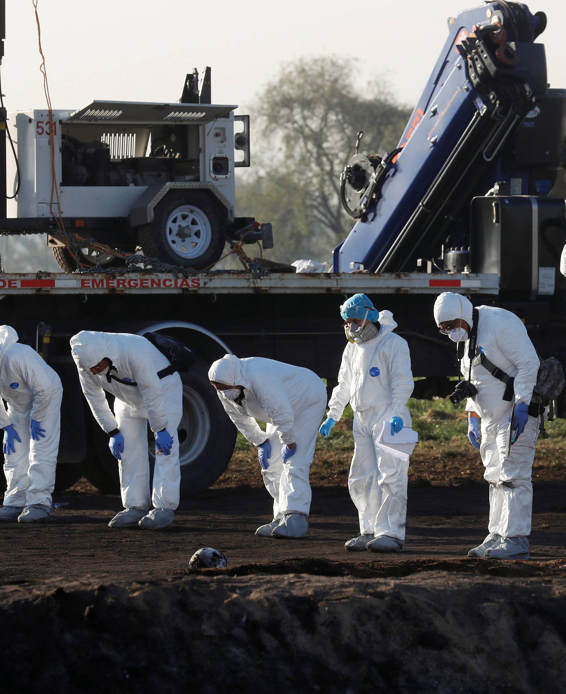 Forensic technicians work at the site where a fuel pipeline ruptured by suspected oil thieves exploded, in the municipality of Tlahuelilpan