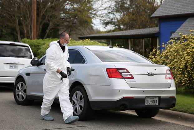 A law enforcement member is seen down the street from the home where Austin serial bomber Mark Anthony Conditt lived in Pflugerville