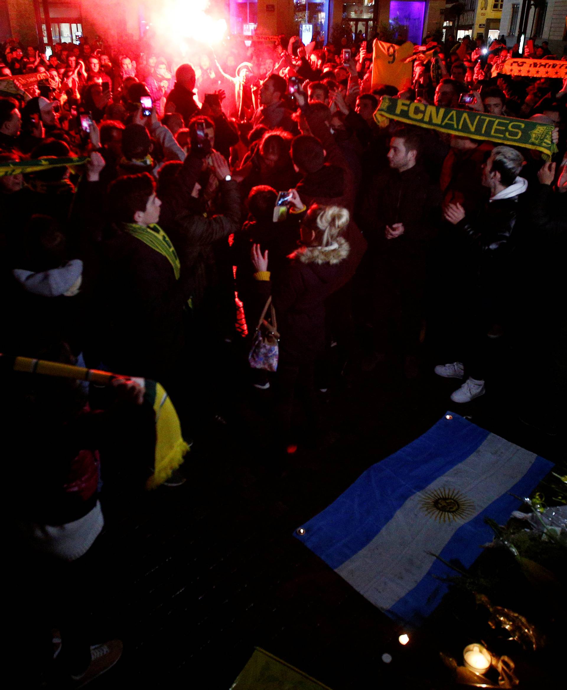 Fans gather near a row of yellow tulips in Nantes' city center after news that newly-signed Cardiff City soccer player Emiliano Sala was missing after the light aircraft he was travelling in disappeared between France and England