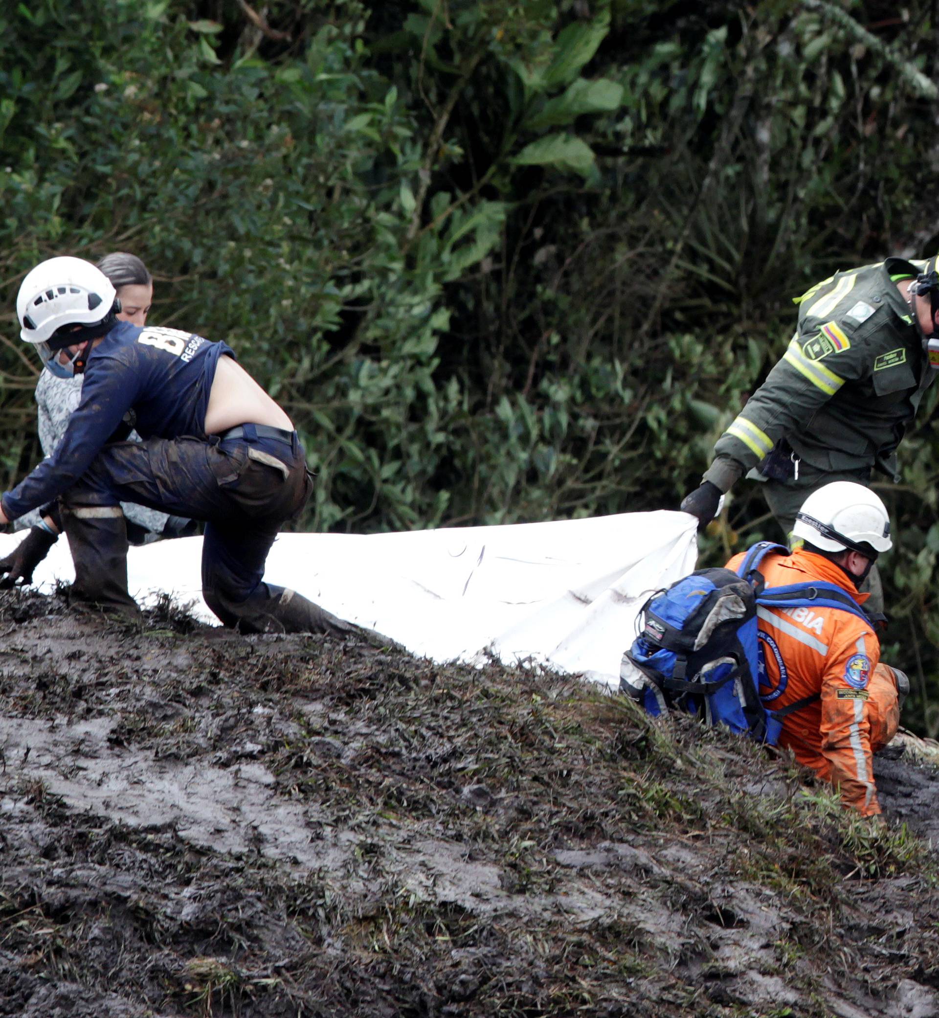 Rescue workers carry the body of a victim from a plane that crashed into the Colombian jungle with Brazilian soccer team Chapecoense onboard, near Medellin