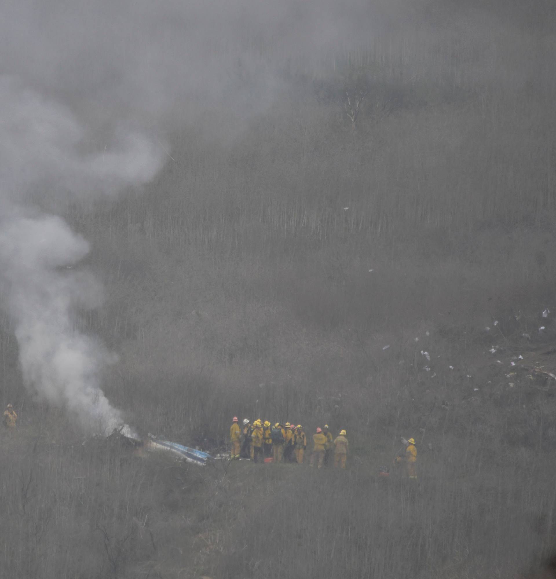 LA county firefighters work at the scene of a helicopter crash that reportedly killed Kobe Bryant in Calabasas