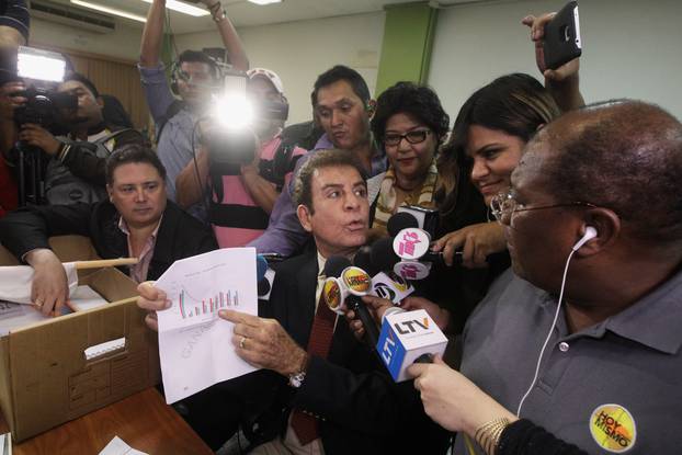 Nasralla, presidential candidate for the Opposition Alliance Against the Dictatorship, shows a graphic to reporters while formally requesting to annul the results of the still-unresolved presidential election, in Tegucigalpa