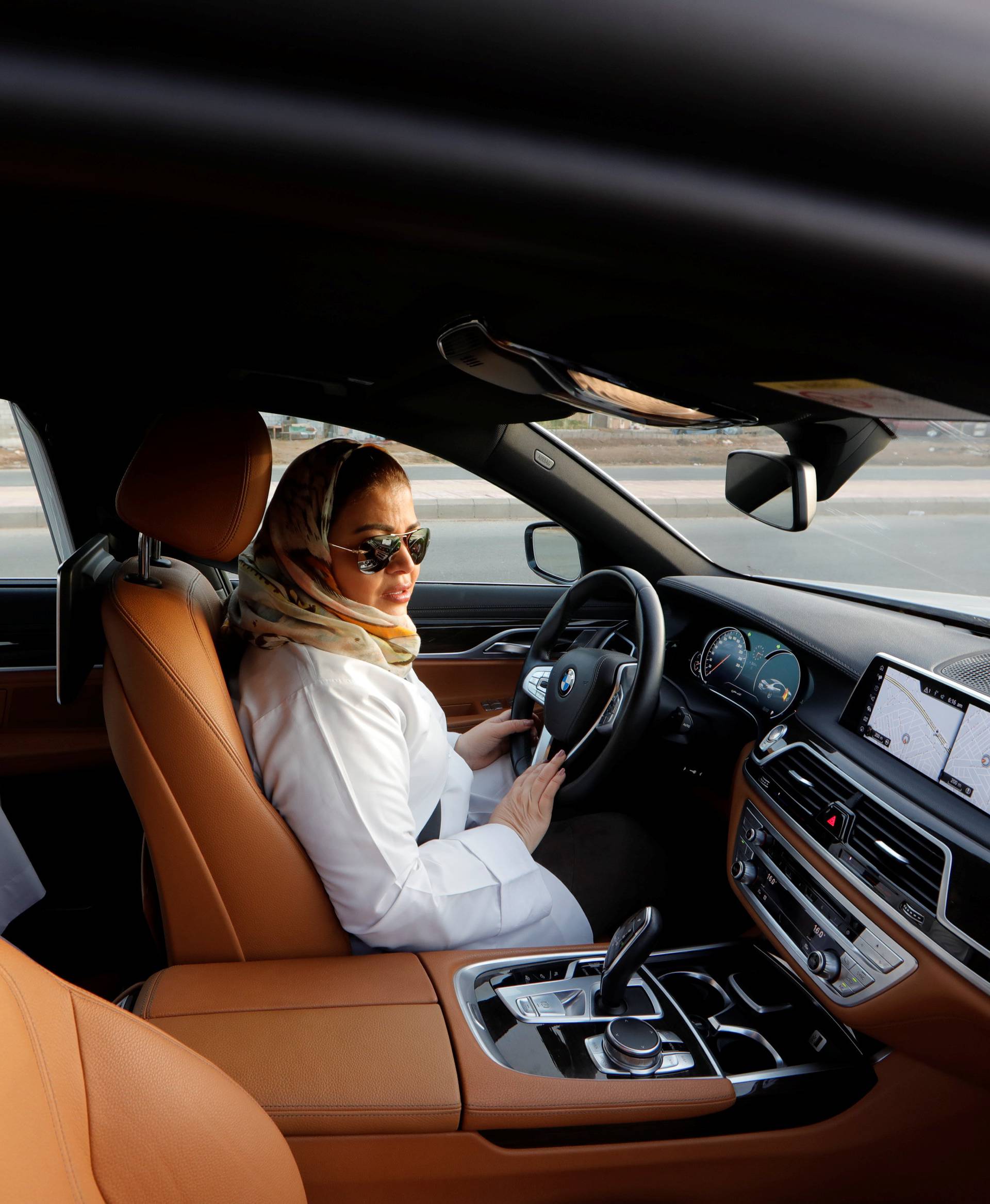 Samira al-Ghamdi, a practicing psychologist, drives her car to work, in Jeddah