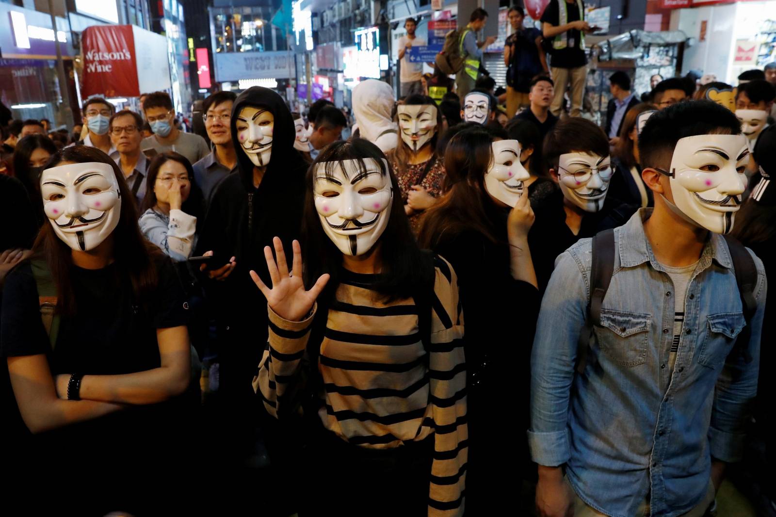 Anti-government protesters wear Guy Fawkes masks during a Halloween march in Lan Kwai Fong, Central district, Hong Kong