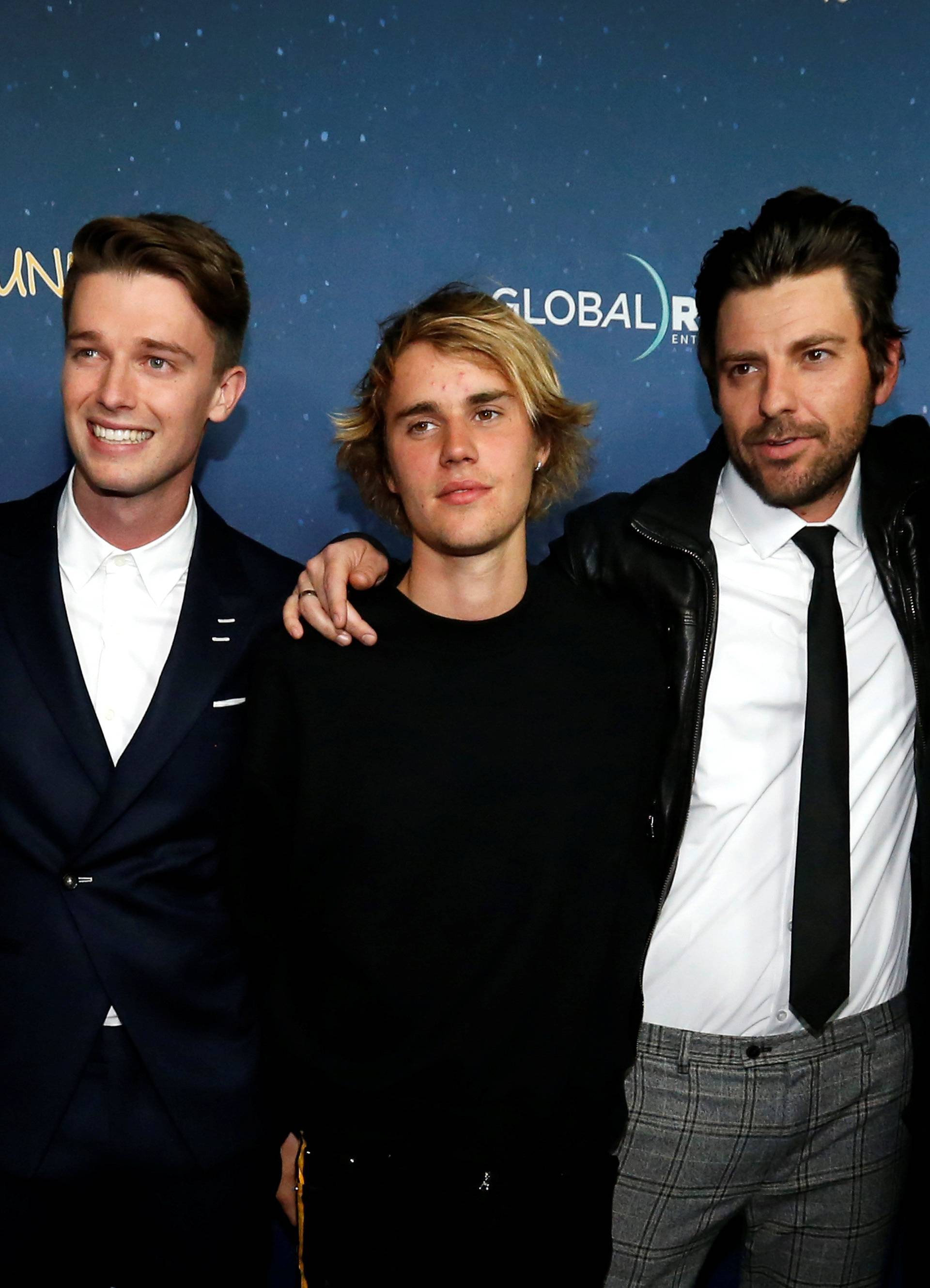 Cast member Schwarzenegger and recording artist Bieber and friends pose at the premiere of "Midnight Sun" in Los Angeles