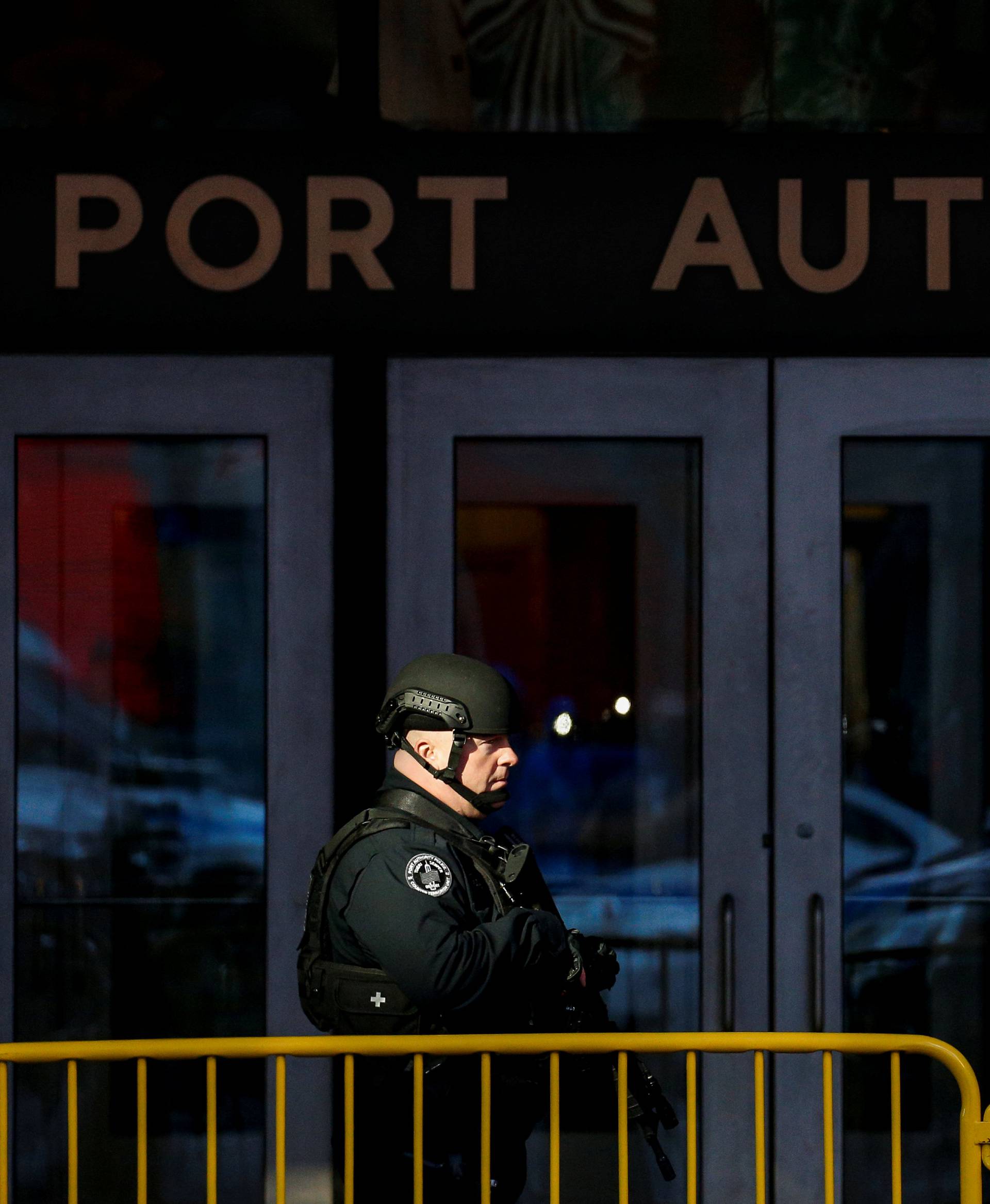 NYPD officer stands outside the New York Port Authority Bus Terminal, after reports of an explosion, in New York City