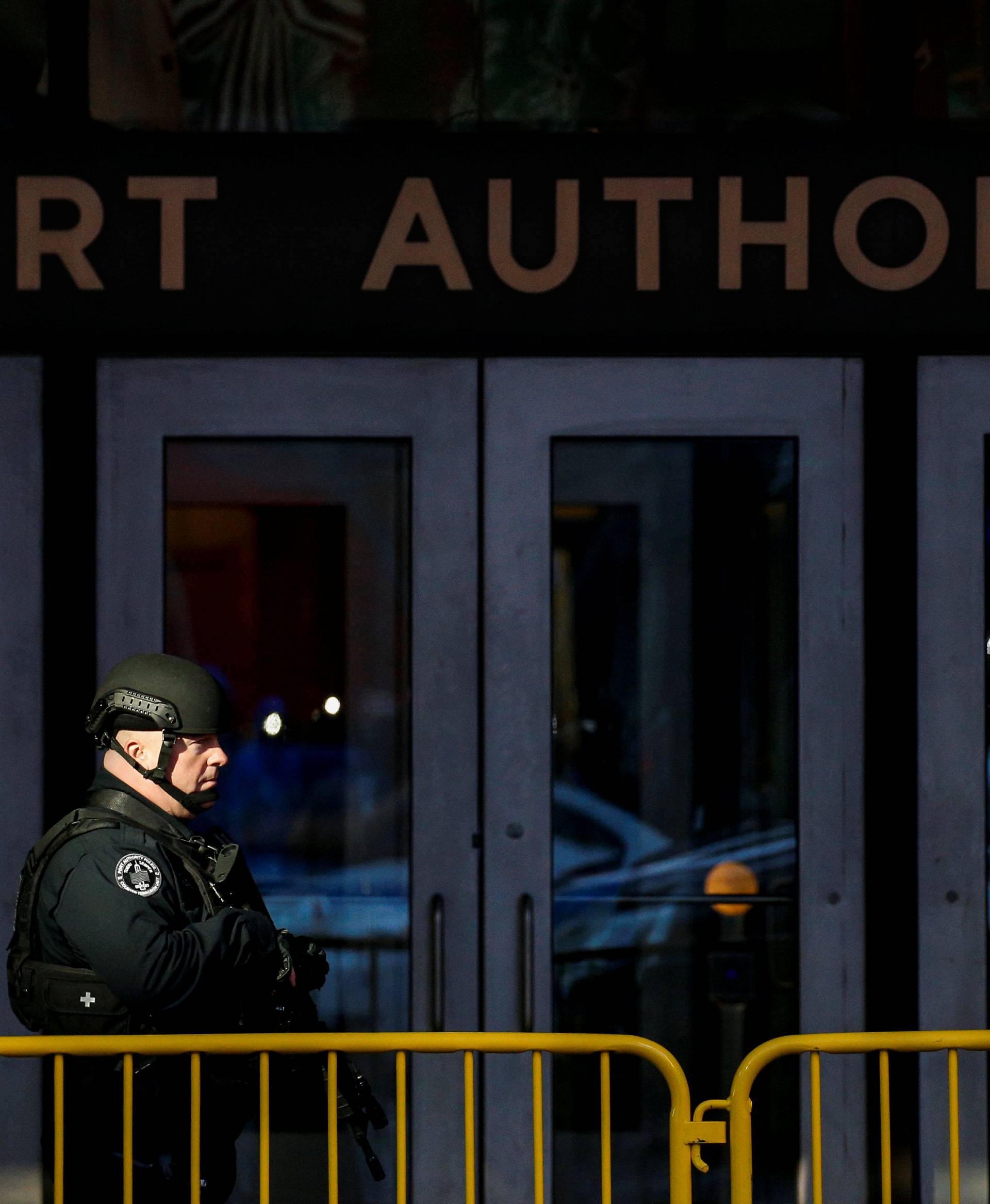 NYPD officer stands outside the New York Port Authority Bus Terminal, after reports of an explosion, in New York City