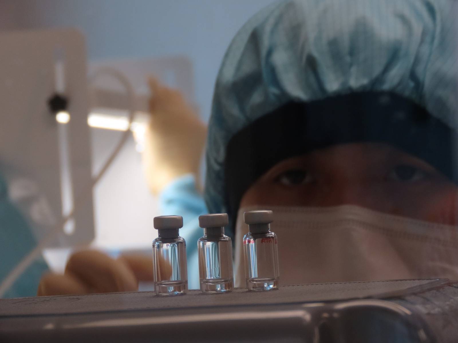 A scientist checks quality control of vaccine vials for correct volume at the Clinical Biomanufacturing Facility (CBF) in Oxford