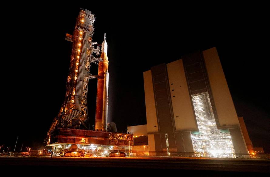NASA's next-generation moon rocket, the Space Launch System (SLS) rocket with the Orion crew capsule, rolls again to Pad 39B for launch