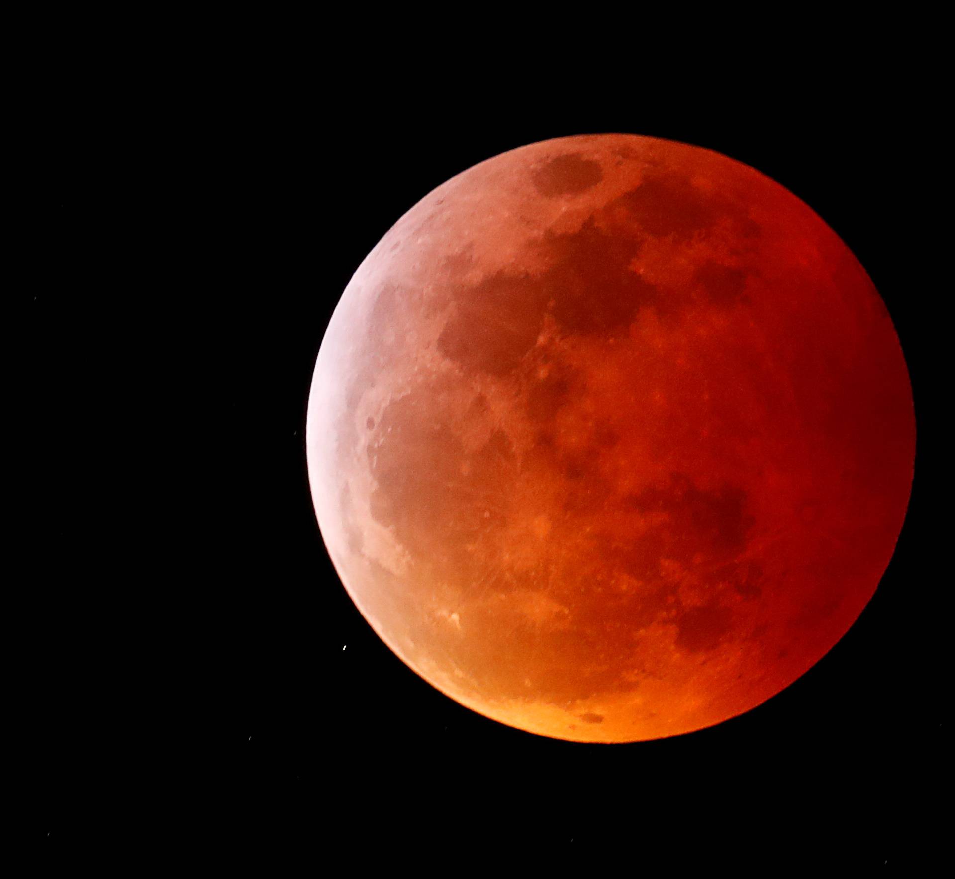 A total lunar eclipse that is called a 'Super Blood Wolf Moon' is seen from Encinitas, California